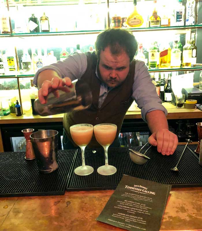 Thomas Hay-Owens pouring cocktail for top 10 Tennessee calling