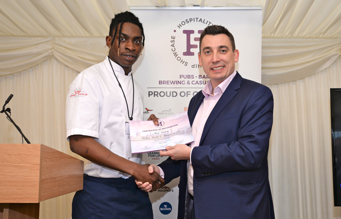 Fuller's Chefs' Guild Apprentice Shey Soetan receives his certificate of recognition.